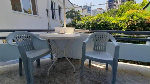 two chairs and a table on a patio at Guesthouse Next to beach in Batumi