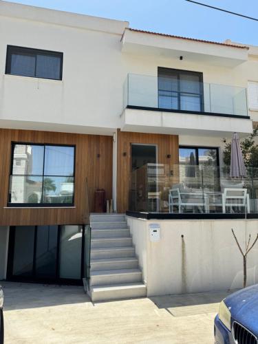 a house with a staircase and a balcony at Larnaca Centre Villa in Larnaca