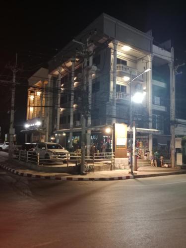 a building with a car parked in front of it at night at HiSSS Style ชะอำ in Cha Am