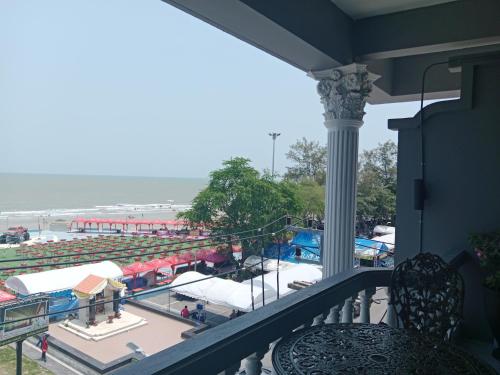 a balcony with a view of the beach at HiSSS Style ชะอำ in Cha Am