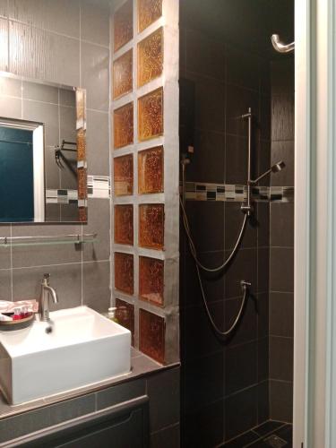 a bathroom with a sink and a shower at HiSSS Style ชะอำ in Cha Am