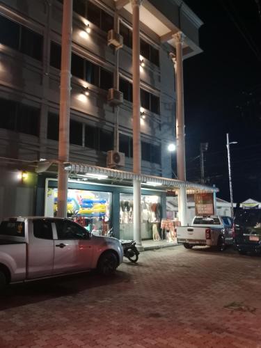 a car parked in front of a building at night at HiSSS Style ชะอำ in Cha Am