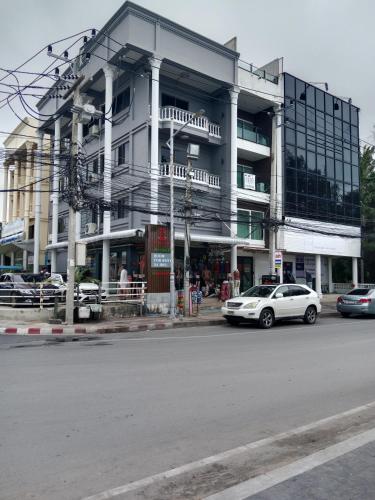 a white car parked in front of a building at HiSSS Style ชะอำ in Cha Am
