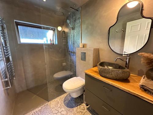 a bathroom with a sink and a toilet and a shower at Cosy and modern Chalet in Grímsnes, south of Iceland - Birta Rentals in Kerhraun