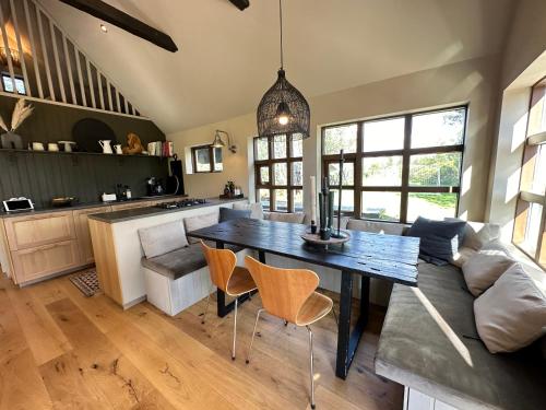 a kitchen and living room with a table and a couch at Cosy and modern Chalet in Grímsnes, south of Iceland - Birta Rentals in Kerhraun