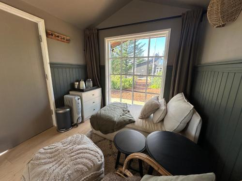 a small room with a bed and a window at Cosy and modern Chalet in Grímsnes, south of Iceland - Birta Rentals in Kerhraun
