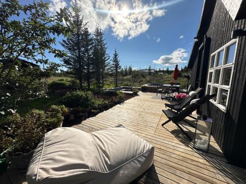 a deck with a cover on a house at Cosy and modern Chalet in Grímsnes, south of Iceland - Birta Rentals in Kerhraun
