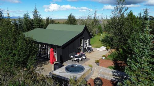 an overhead view of a black building with a patio at Cosy and modern Chalet in Grímsnes, south of Iceland - Birta Rentals in Kerhraun