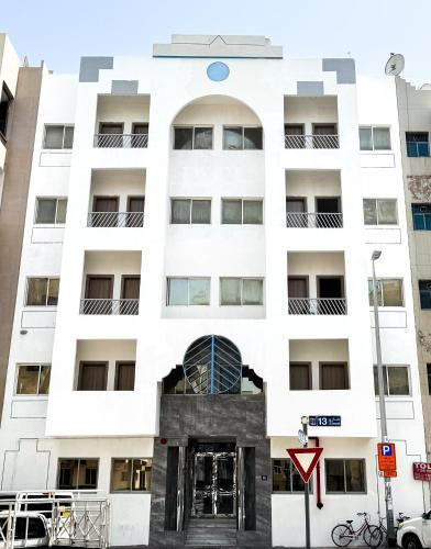 a white building with a door in front of it at Baraha Star Residence in Dubai