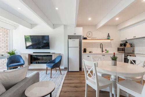 a kitchen and living room with a table and chairs at Blairgowrie Beach Townhouse Opposite the beach! in Blairgowrie