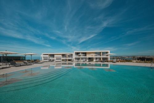 a large swimming pool in front of a building at West Cliffs Ocean and Golf Resort in Casal da Lagoa Seca