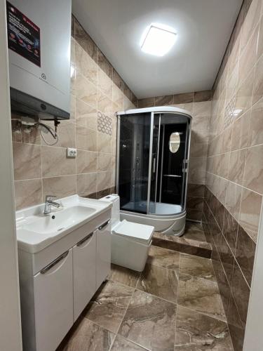 a bathroom with a sink and a toilet at Гостевой дом in Tokmok