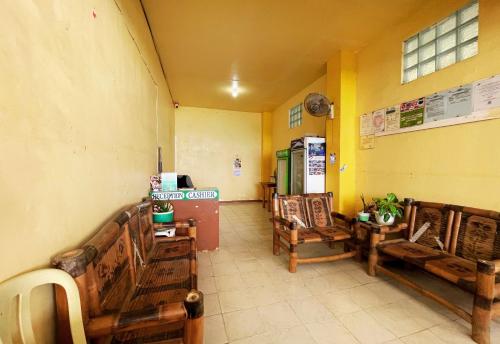 a room with wooden benches in a room at White Beach Hotel Puerto Galera powered by Cocotel in Puerto Galera