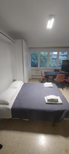 a bedroom with a large bed and chairs and windows at La Casa dell'Architetto in Bari