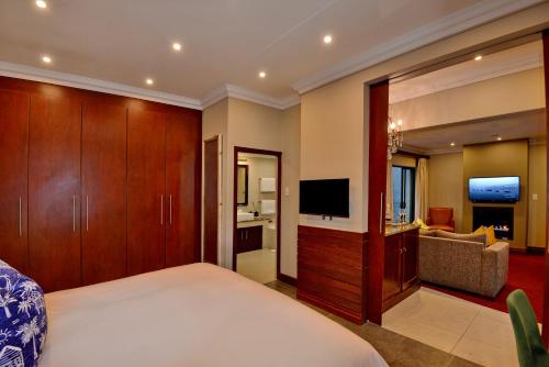 a hotel room with a bed and a television at The Residence in Johannesburg