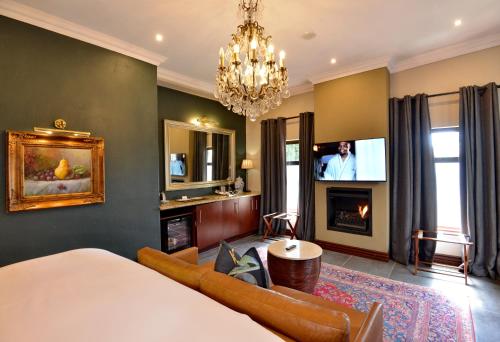 a bedroom with a bed and a fireplace and a tv at The Residence in Johannesburg