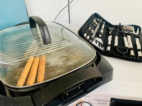 a bunch of cigars in a pan on a stove at 007Dickoya in Dikoya