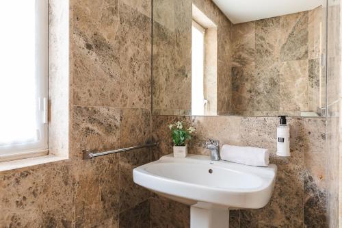 a bathroom with a sink and a mirror at Ona Lomas Village - La Manga Club in La Manga del Mar Menor