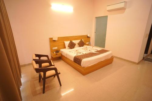 a bedroom with a bed and a chair at Dhawala Resort By Aamod in Alwar