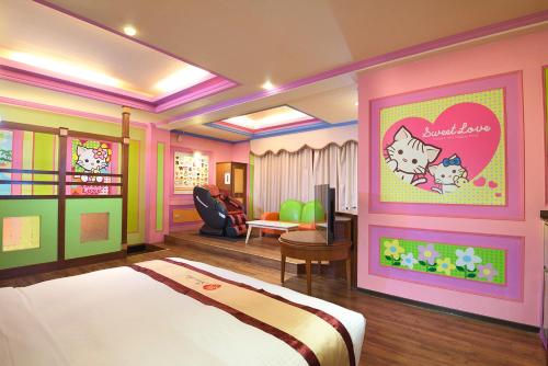 a bedroom with a bed and a living room at Summer House Motel in Tainan