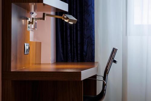 a desk with a lamp and a chair in a room at Holiday Inn Express Bilbao Airport by IHG in Derio