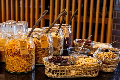 a table with many jars of cereal and other foods at Holiday Inn Express Bilbao Airport by IHG in Derio
