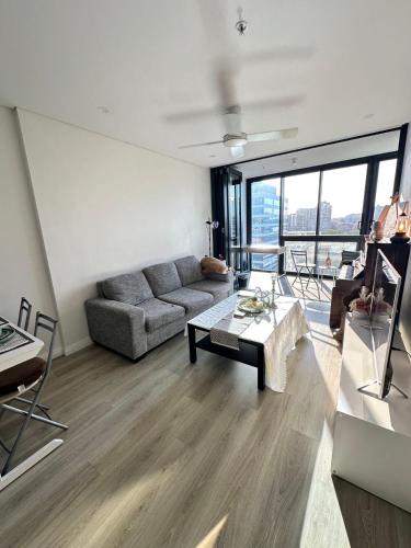 a living room with a couch and a table at breathtaking Fortitude valley Apartment in Brisbane