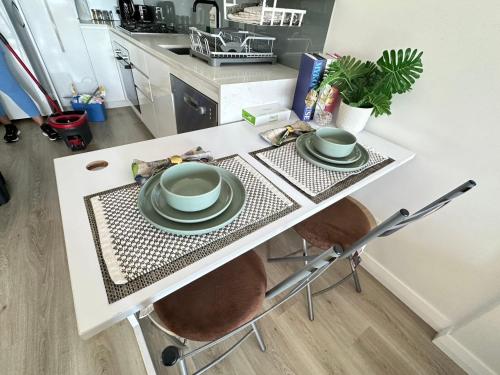 a kitchen table with two plates on it at breathtaking Fortitude valley Apartment in Brisbane