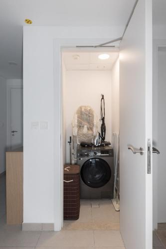 a kitchen with a washing machine in a room at 1BD Partial Burj Al Arab View Prime Location in Dubai