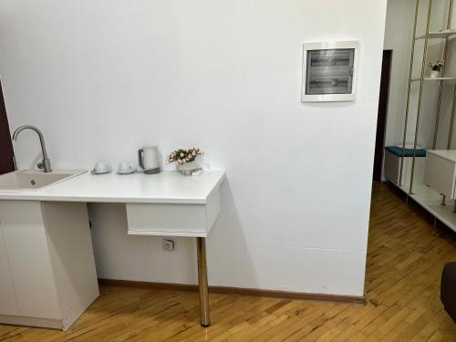 a white desk with a sink in a room at Hotel Tigran Mets Yerevan in Yerevan