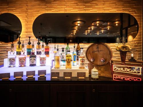 a bar with a display of different types of whiskey at Super Hotel Sendaieki Higashiguchi Tennenonsen in Sendai