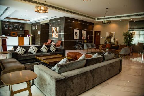 a large living room with couches and tables at GiNGER LUXURY APARTMENT JUFFAIR in Juffair