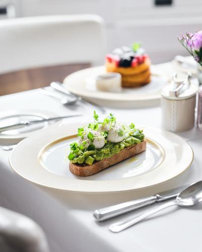 a white plate with a piece of food on a table at The Adria in London