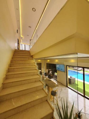 a staircase in a building with a view of the ocean at Jumeirah Chalet جميرا شاليه in Amman