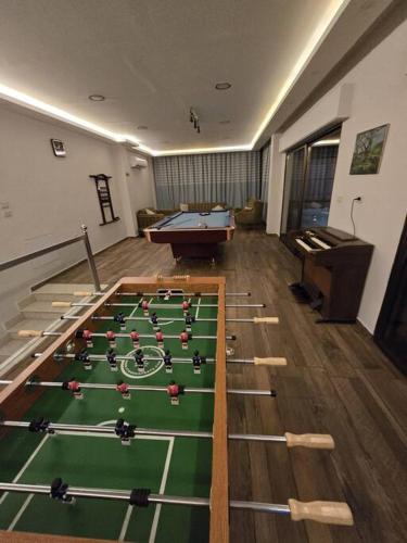 a room with a pool table in the middle of it at Jumeirah Chalet جميرا شاليه in Amman