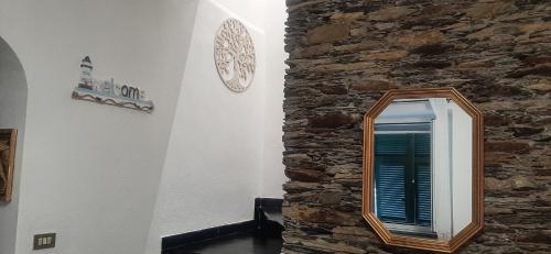 a mirror in a room with a stone wall at Ca Du Stea in Lavagna