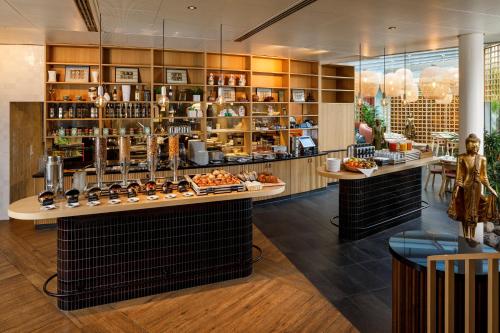 a restaurant with a counter with food on display at Alpha by Fassbind in Lausanne