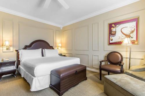 a hotel room with a bed and a couch at Inn at the Mill, an Ascend Collection Hotel in Fayetteville