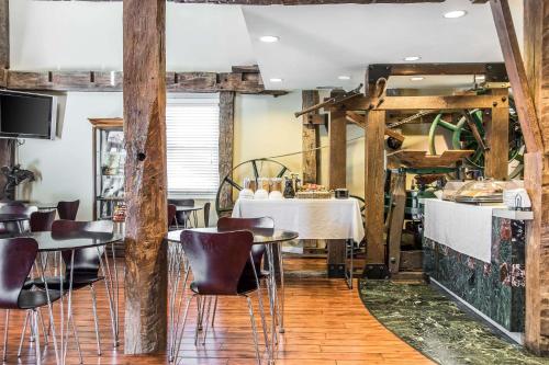 a restaurant with tables and chairs in a room at Inn at the Mill, an Ascend Collection Hotel in Fayetteville