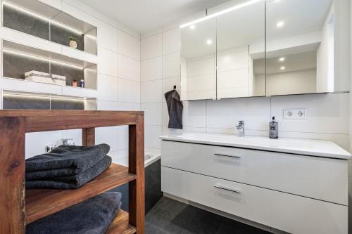 a white bathroom with a sink and a counter at Ferienhaus Unterm Schloss in Bautzen