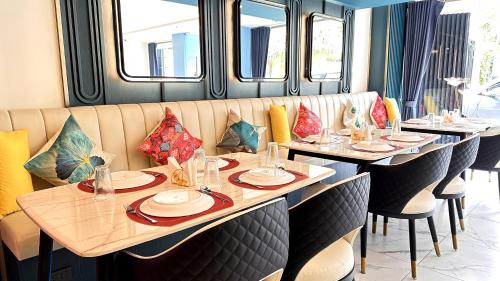 a dining room with tables and chairs in a train at SQ Boutique Hotel in Bangkok