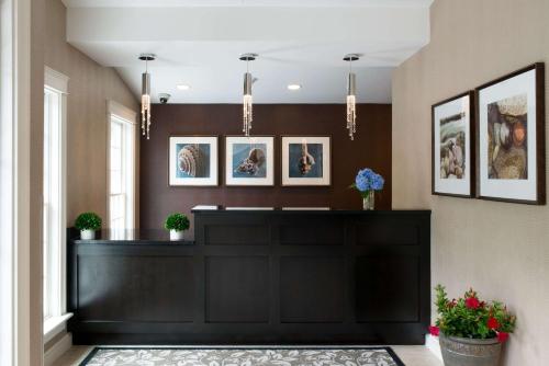 a hotel lobby with a black reception desk at Port Inn & Suites Kennebunk, an Ascend Collection Hotel in Kennebunk