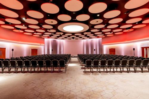 an empty room with chairs and a large ceiling at Crowne Plaza Newcastle - Stephenson Quarter by IHG in Newcastle upon Tyne