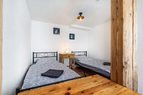 a bedroom with two beds and a wooden floor at Ferienhaus Unterm Schloss in Bautzen