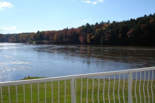 a view of a river behind a white fence at Riverside Hotel, an Ascend Collection Hotel in West Chesterfield