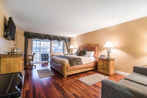a bedroom with a bed and a large window at Riverside Hotel, an Ascend Collection Hotel in West Chesterfield