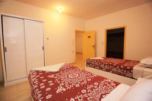 a hotel room with two beds and a closet at Luxor View Hostel in Luxor