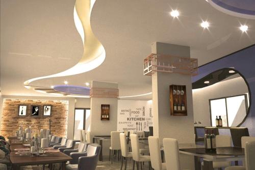 a dining room with tables and white chairs at Le Caravelle Beirut in Beirut