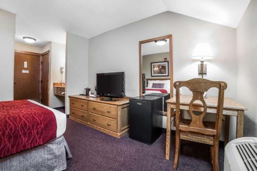 a hotel room with a bed and a desk with a television at K Bar S Lodge, an Ascend Collection Hotel in Keystone