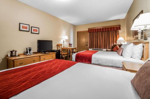 a hotel room with two beds and a television at K Bar S Lodge, an Ascend Collection Hotel in Keystone